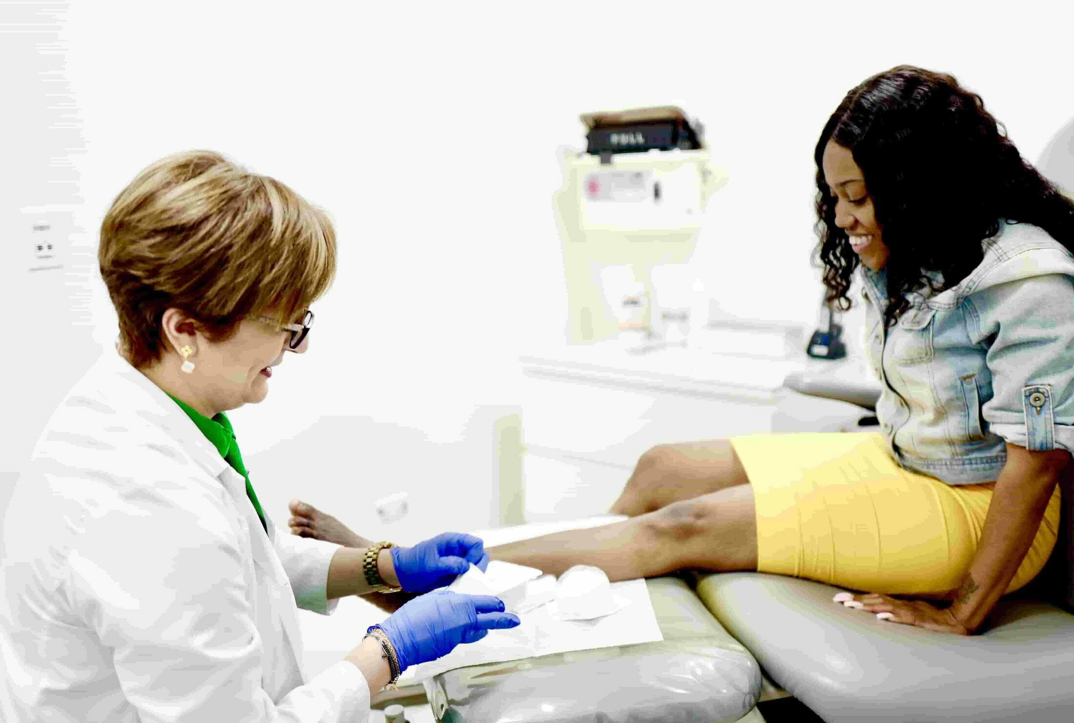 Podiatrist working with female patient