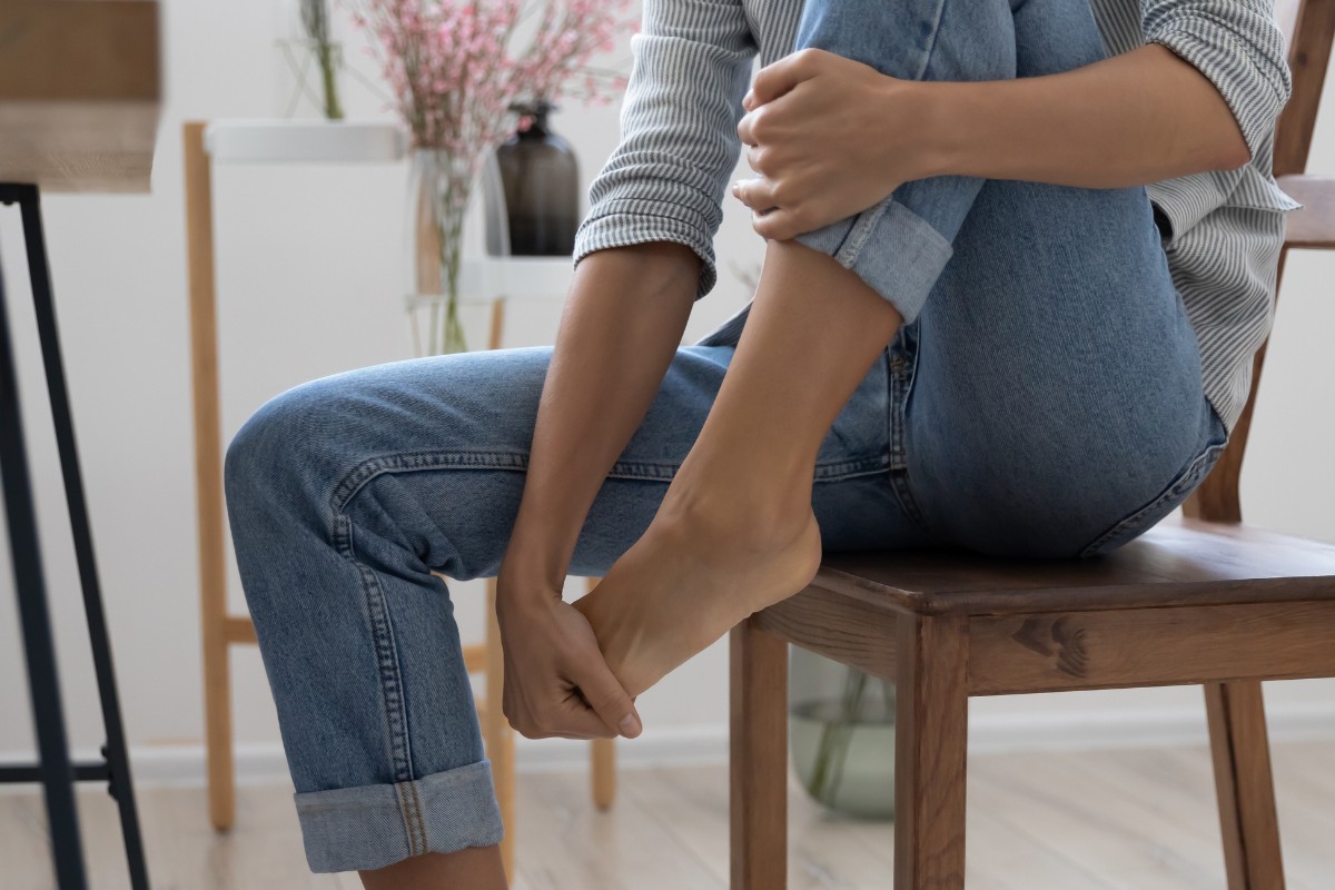 Woman holding foot in pain