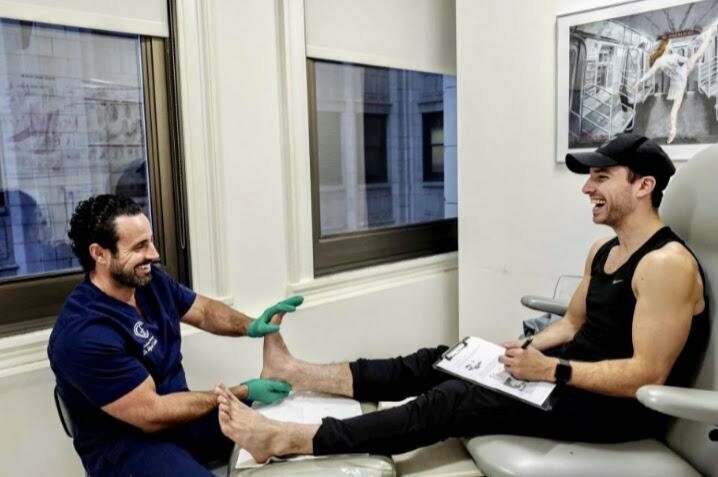 Dr. Cunha working with male patient's foot