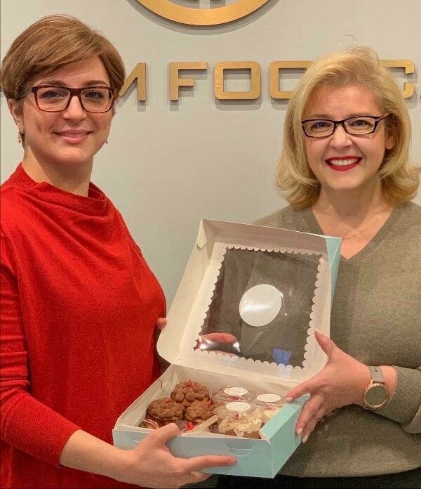Women holding donuts