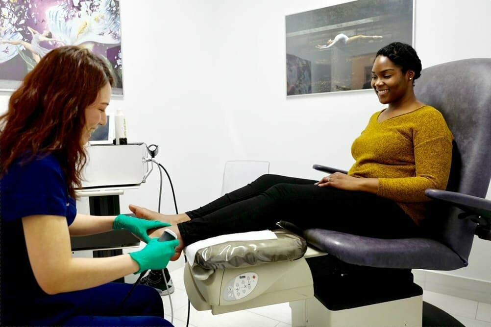 podiatrist working with patient