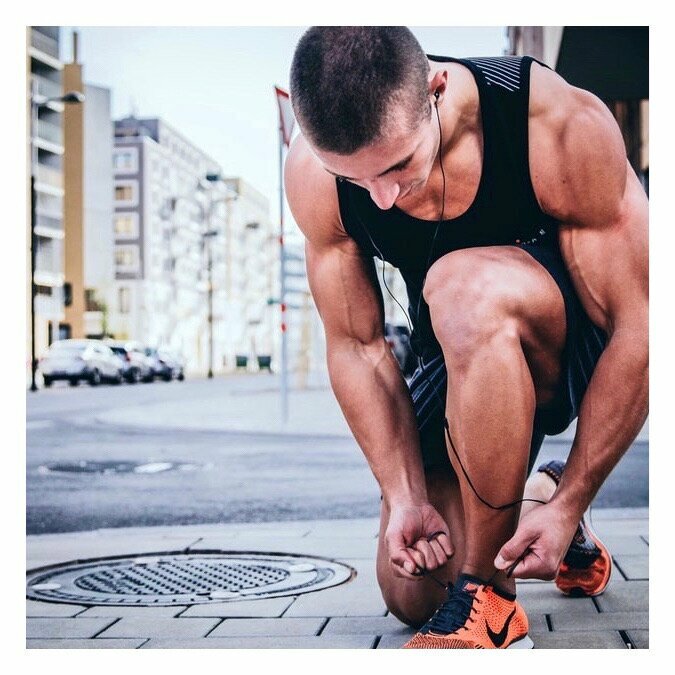 Athletic man tying shoe