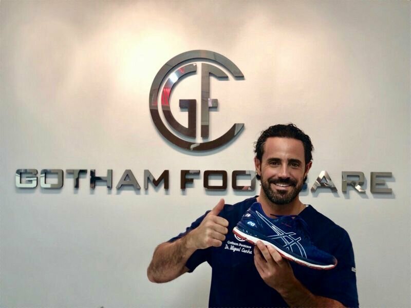 Dr. Cunha in front of Gotham Footcare sign